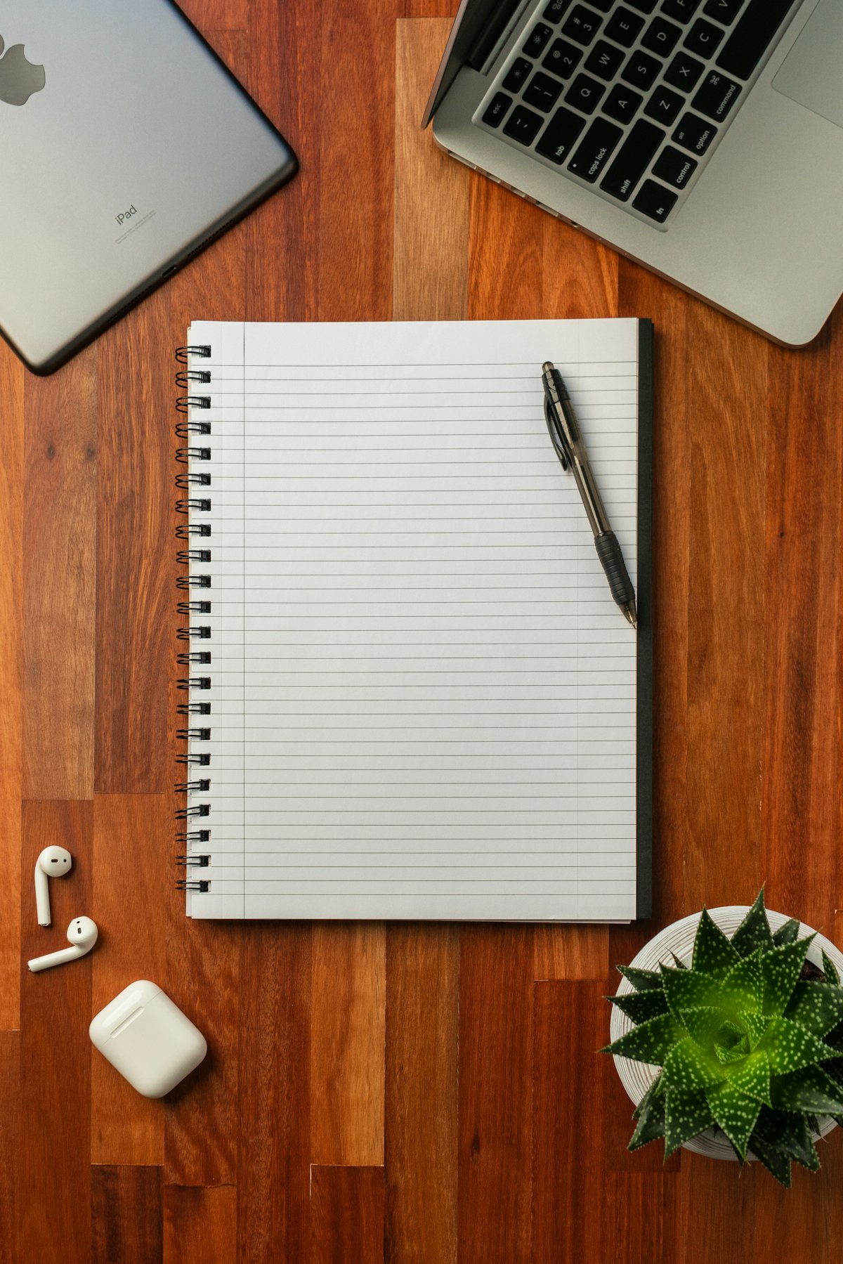 A pen resting on a blank notebook, standing in for the handwritten recovery seed backup