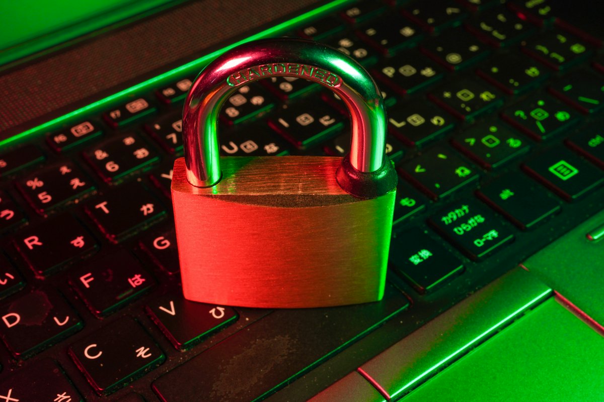 A red padlock resting on a black computer keyboard